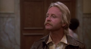 Movie still from “Where the Buffalo Roam” (1980), directed by Art Linson – A person wearing a jacket; Close Up shot, Low angle