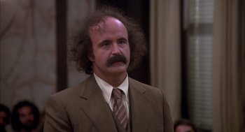 Movie still from “Where the Buffalo Roam” (1980), directed by Art Linson – A man in a brown suit and a brown tie; Close Up shot, Low angle