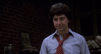 Movie still from “Where the Buffalo Roam” (1980), directed by Art Linson – A man wearing a red tie standing in front of a brick wall; Close Up shot, High angle