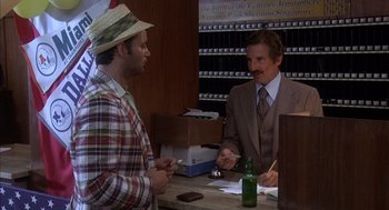 Movie still from “Where the Buffalo Roam” (1980), directed by Art Linson – A man in a suit and hat talking to a man in a suit; Medium shot, Over the shoulder angle