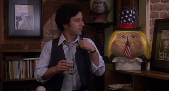 Movie still from “Where the Buffalo Roam” (1980), directed by Art Linson – A man holding a phone and a glass of beer; Medium shot, Low angle