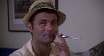 Movie still from “Where the Buffalo Roam” (1980), directed by Art Linson – A person wearing a straw hat; Close Up shot, Low angle