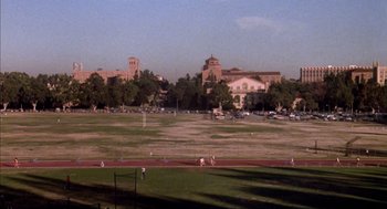 Movie still from “Where the Buffalo Roam” (1980), directed by Art Linson – A baseball field in a large city with a lot of trees; Extreme Wide shot, High angle