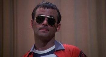 Movie still from “Where the Buffalo Roam” (1980), directed by Art Linson – A person wearing sunglasses; Close Up shot, Low angle