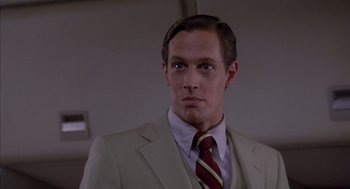 Movie still from “Where the Buffalo Roam” (1980), directed by Art Linson – A man in a suit and tie looking at the camera; Close Up shot, Low angle