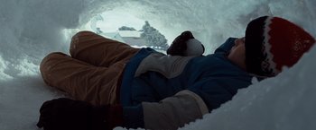 Movie still from “Where the Wild Things Are” (2009), directed by Spike Jonze – A person laying on the ground in the snow; Wide shot, Low angle