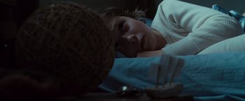 Movie still from “Where the Wild Things Are” (2009), directed by Spike Jonze – A young girl laying in bed with a ball of yarn on the floor; Close Up shot, High angle