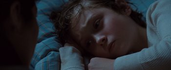 Movie still from “Where the Wild Things Are” (2009), directed by Spike Jonze – A young child laying in a bed with his head resting on a pillow; Close Up shot, High angle