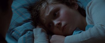 Movie still from “Where the Wild Things Are” (2009), directed by Spike Jonze – A young child laying in bed with his head resting on a pillow; Close Up shot, High angle