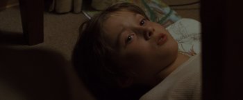 Movie still from “Where the Wild Things Are” (2009), directed by Spike Jonze – A young boy laying on the floor looking at the camera; Close Up shot, High angle