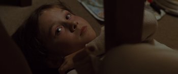 Movie still from “Where the Wild Things Are” (2009), directed by Spike Jonze – A young girl laying on a bed looking up at the camera; Close Up shot, High angle