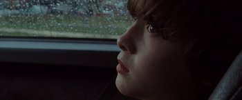 Movie still from “Where the Wild Things Are” (2009), directed by Spike Jonze – A young boy looking out the window of a car; Close Up shot, Over the shoulder angle