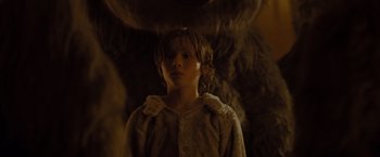 Movie still from “Where the Wild Things Are” (2009), directed by Spike Jonze – A young boy wearing a fur coat in a dimly - lit room; Close Up shot, Low angle