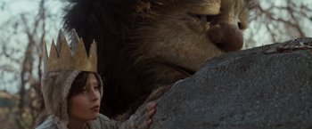 Movie still from “Where the Wild Things Are” (2009), directed by Spike Jonze – A person wearing a paper crown next to a lion; Close Up shot, Low angle
