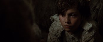 Movie still from “Where the Wild Things Are” (2009), directed by Spike Jonze – A young boy wearing a fur coat looking into the distance; Close Up shot, Over the shoulder angle