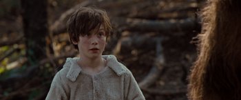 Movie still from “Where the Wild Things Are” (2009), directed by Spike Jonze – A young boy wearing a furry coat in a wooded area; Close Up shot, Over the shoulder angle