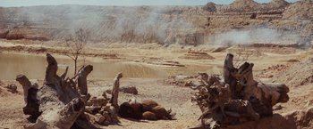 Movie still from “Where the Wild Things Are” (2009), directed by Spike Jonze – A man standing next to an animal in the middle of the desert; Extreme Wide shot, High angle