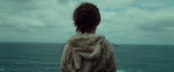 Movie still from “Where the Wild Things Are” (2009), directed by Spike Jonze – A person wearing a fur coat looking out at the ocean; Close Up shot, Over the shoulder angle