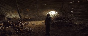 Movie still from “Where the Wild Things Are” (2009), directed by Spike Jonze – A person standing in the dark in front of an entrance to a cave; Wide shot, Low angle