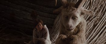 Movie still from “Where the Wild Things Are” (2009), directed by Spike Jonze – A woman sitting in front of an animal with long horns; Medium shot, Over the shoulder angle