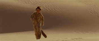 Movie still from “Where the Wild Things Are” (2009), directed by Spike Jonze – A young boy running through the sand dunes; Wide shot, High angle