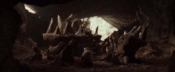 Movie still from “Where the Wild Things Are” (2009), directed by Spike Jonze – A group of people sitting in a cave with rocks; Extreme Wide shot, Low angle