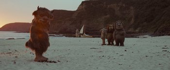 Movie still from “Where the Wild Things Are” (2009), directed by Spike Jonze – A group of animals standing on top of a sandy beach next to a boat; Wide shot, Low angle