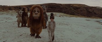 Movie still from “Where the Wild Things Are” (2009), directed by Spike Jonze – A group of people walking on the beach with a monkey; Wide shot, Low angle