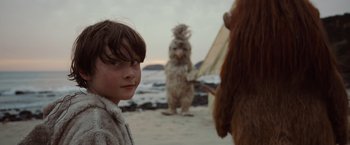 Movie still from “Where the Wild Things Are” (2009), directed by Spike Jonze – A young girl standing on a beach next to an animal; Close Up shot, Over the shoulder angle