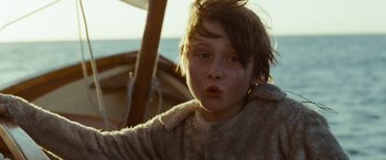 Movie still from “Where the Wild Things Are” (2009), directed by Spike Jonze – A young boy is sitting on a boat in the water; Close Up shot, Low angle