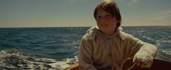 Movie still from “Where the Wild Things Are” (2009), directed by Spike Jonze – A young boy sitting on a boat in the water; Close Up shot, High angle