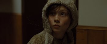 Movie still from “Where the Wild Things Are” (2009), directed by Spike Jonze – A young boy wearing a hooded jacket and a fur coat; Close Up shot, High angle