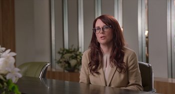 Movie still from “Where'd You Go, Bernadette” (2019), directed by Richard Linklater – A woman sitting at a table in front of a mirror; Medium shot, Over the shoulder angle