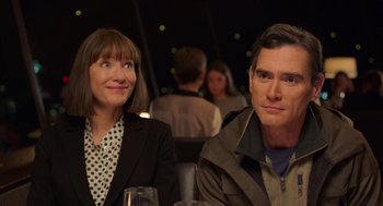 Movie still from “Where'd You Go, Bernadette” (2019), directed by Richard Linklater – A man and a woman sitting next to each other at a table; Close Up shot, Over the shoulder angle