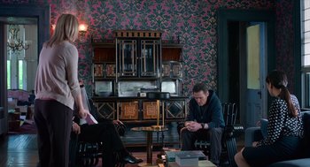 Movie still from “Where'd You Go, Bernadette” (2019), directed by Richard Linklater – A man and a woman sitting in a living room next to each other; Wide shot, High angle