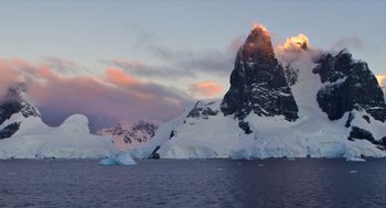 Movie still from “Where'd You Go, Bernadette” (2019), directed by Richard Linklater – A large body of water near a mountain range; Extreme Wide shot, High angle