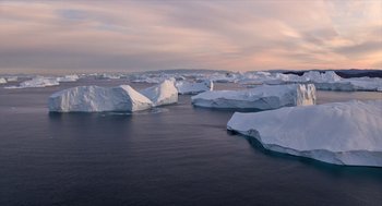 Movie still from “Where'd You Go, Bernadette” (2019), directed by Richard Linklater – Many icebergs floating in the water; Extreme Wide shot, High angle