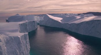 Movie still from “Where'd You Go, Bernadette” (2019), directed by Richard Linklater – A view of a body of water and a mountain range; Extreme Wide shot, Overhead angle