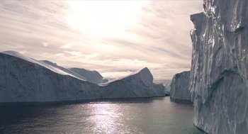 Movie still from “Where'd You Go, Bernadette” (2019), directed by Richard Linklater – A view of a body of water with a mountain in the background; Extreme Wide shot, Low angle