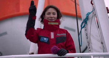 Movie still from “Where'd You Go, Bernadette” (2019), directed by Richard Linklater – A woman in a red jacket on a boat; Medium shot, Low angle