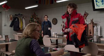 Movie still from “Where'd You Go, Bernadette” (2019), directed by Richard Linklater – Two women and a man are standing at a table; Medium shot, Over the shoulder angle