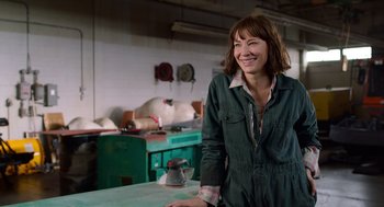 Movie still from “Where'd You Go, Bernadette” (2019), directed by Richard Linklater – A woman standing next to a table in a room; Medium shot, Over the shoulder angle