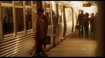 Movie still from “While You Were Sleeping” (1995), directed by Jon Turteltaub – A woman with a briefcase walking next to a train; Wide shot, High angle