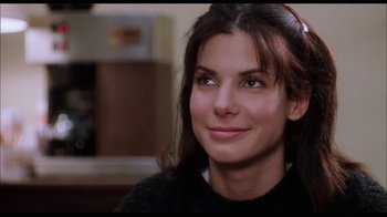 Movie still from “While You Were Sleeping” (1995), directed by Jon Turteltaub – A person with long dark hair; Close Up shot, High angle