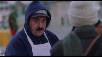 Movie still from “While You Were Sleeping” (1995), directed by Jon Turteltaub – A man wearing an apron and a hood talking to another man; Close Up shot, Over the shoulder angle