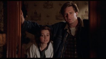 Movie still from “While You Were Sleeping” (1995), directed by Jon Turteltaub – A man and a woman standing next to each other in a room; Medium shot, Low angle