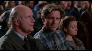 Movie still from “While You Were Sleeping” (1995), directed by Jon Turteltaub – A group of people sitting in a room; Close Up shot, Over the shoulder angle