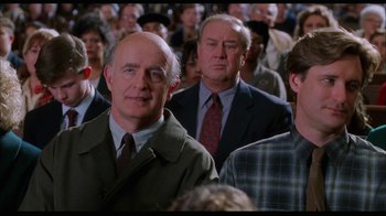 Movie still from “While You Were Sleeping” (1995), directed by Jon Turteltaub – A group of people standing in a room; Medium shot, Over the shoulder angle