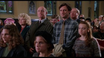 Movie still from “While You Were Sleeping” (1995), directed by Jon Turteltaub – A group of people standing in a room; Medium shot, High angle