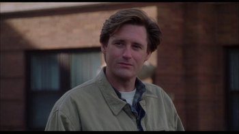 Movie still from “While You Were Sleeping” (1995), directed by Jon Turteltaub – A person wearing a shirt and a jacket; Close Up shot, Over the shoulder angle
